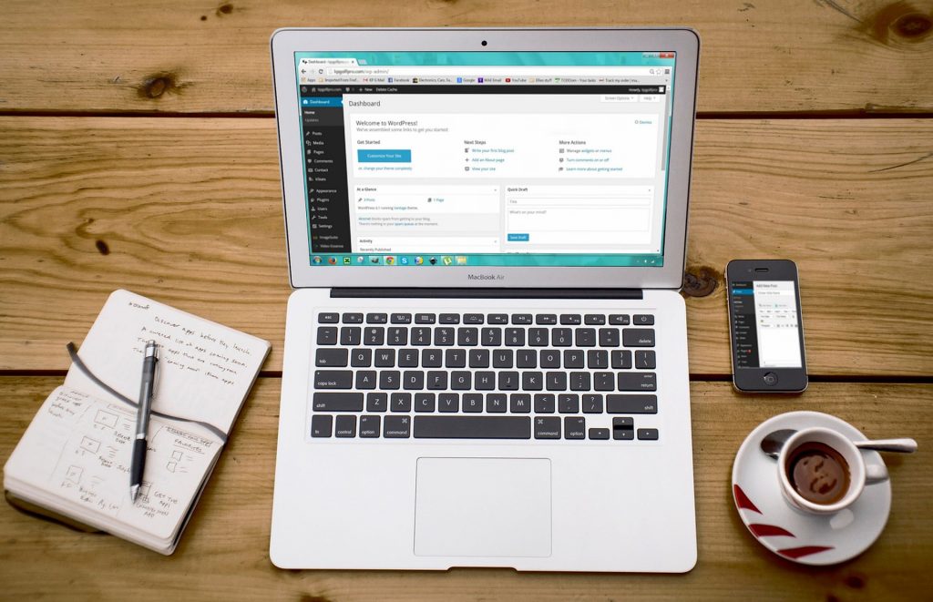 Author websites: a photo of a desk with a laptop, book and coffee